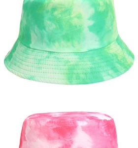 Detailed comparison of green and red tie-dye reversible bucket hats in soft cotton
