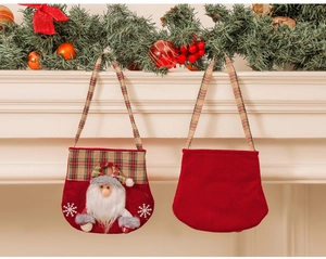 Detailed front and back view of a plush Santa Claus fabric gift bag on a festive mantel