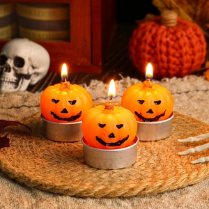 Set of three orange pumpkin tea light candles with Jack-o-lantern faces for Halloween decor