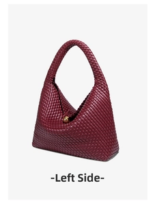 Detailed shot of burgundy woven leather bag featuring a distinctive gold sphere clasp