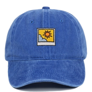 Detailed front view of blue washed cotton baseball cap with sun and clouds embroidery