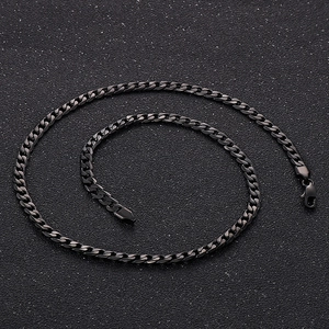Macro detail of flat NK chain link structure and lobster clasp in black stainless steel