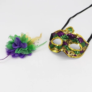 Close-up of purple, green, and gold masquerade mask with feathers and sequins