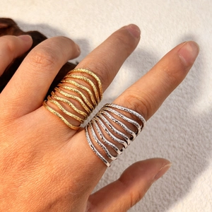 Minimalist stainless steel spiral rings with hammered texture in gold and silver finish