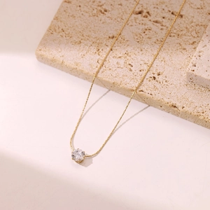 Minimalist gold necklace featuring a sparkling round cubic zirconia pendant for women