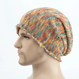 Detail shot of multi-colored knit beanie with distressed holes and dye-style patterns