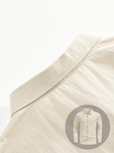 Detailed macro view of beige linen texture and stitching on men's casual short sleeve shirt