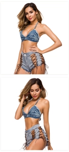 Dettaglio di pantaloncini di jeans a vita alta con lacci laterali e frange orlate