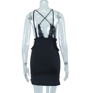 Detail of black lace patchwork and backless criss-cross straps on the slim mini dress
