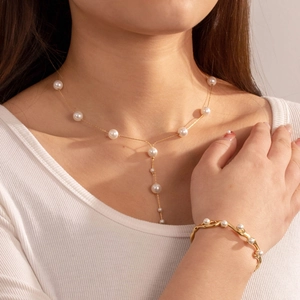 Elegant gold-plated stainless steel Y-necklace and bracelet set with pearl accents