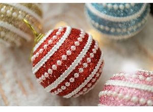 Macro view of Christmas ball ornaments featuring pearl stripes and glitter texture details
