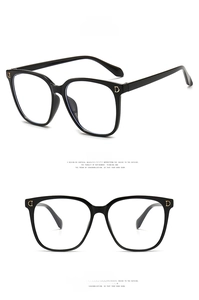 Detailed views of shiny black square frame glasses with gold metal accents