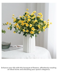 Yellow artificial mini roses in white ceramic fluted vase for home table decoration