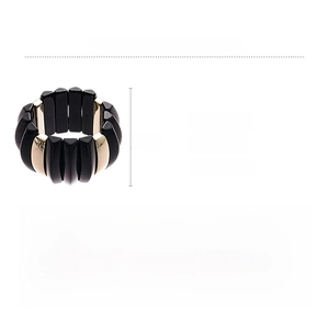 Detail view of bold acrylic stretch bracelet with geometric black and gold prism segments