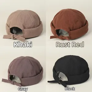 Detail of adjustable back ties on cotton docker caps in four neutral colors