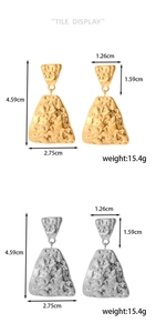 Detail view of geometric hammered metal earrings in gold and silver finishes