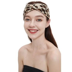 Detail shot of leopard print knit headband with stylish twist knot on fashion model