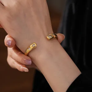 Elegant gold open bangle with drop zirconia crystals for a vintage minimalist look