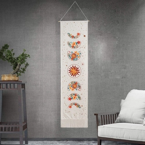 Bohemian tapestry featuring floral moon phase patterns and elegant fringe details