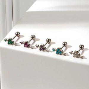 Minimalist heart-shaped cartilage studs with colorful zircons on white steps