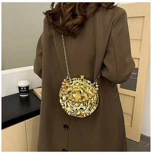 Detailed view of a gold rose-shaped evening bag with metallic finish and chain strap
