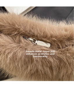 Macro shot of fluffy brown faux fur texture and polished metal zipper pull detail
