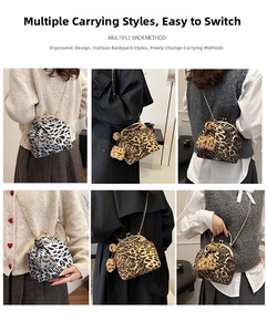 Detail of leopard print kiss-lock shell bag with metal chain strap and pompom charm