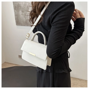 Chic white leather handbag worn as a crossbody bag showing the stylish carrying scale