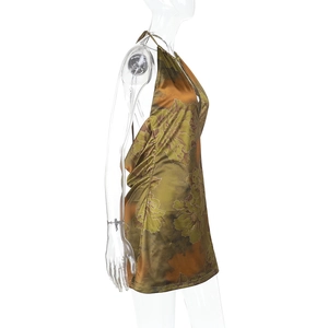 Side view of olive green floral halter neck mini dress in glossy satin fabric on mannequin