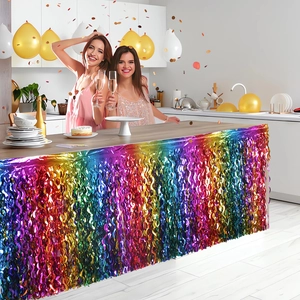 Rainbow foil fringe table skirt for party decorations with women celebrating in a festive setting