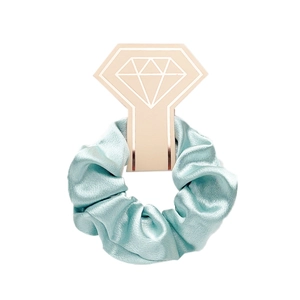 Detail of mint green satin scrunchie on decorative diamond ring card display