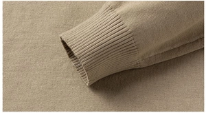 Close-up of the ribbed cuff detail on a slim-fit khaki knitted sweater for men