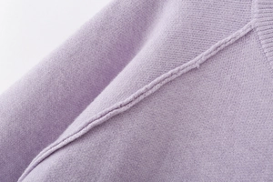 Close-up of the lavender knit sweater showing fine seam stitching and fabric texture