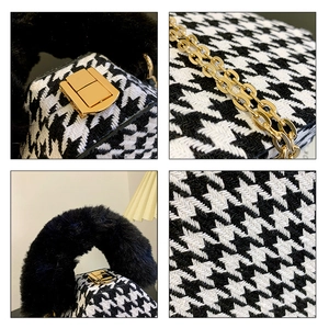 Detail view of houndstooth fabric, golden chain strap and black plush handle of the handbag