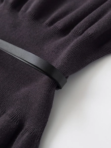 Detail of dark purple ribbed knit dress fabric with a slim black leather belt