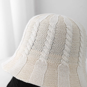 Detailed close-up of cable knit texture on a beige breathable crochet bucket hat