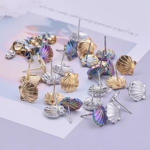 Detailed view of seashell stud earrings in gold, silver and rainbow stainless steel