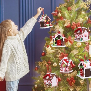 Detail of gingerbread house Christmas tree ornaments with colorful candy motifs and red strings