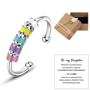 Silver anxiety ring with colorful spinning beads in a gift box with a blessing card