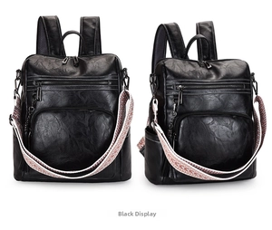 Detail of black faux leather backpack with colorful woven wide shoulder strap accents