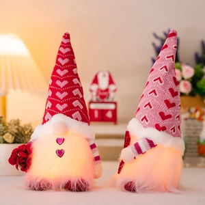 Detail of LED glowing Valentine gnomes with knitted heart hats and a red rose