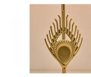 Detail of hand-painted golden iron feather ornament with a luxury metallic texture