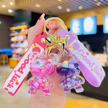 Detailed shot of pink and purple glitter bear keychains with silicone hand straps