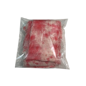 Detailed view of bloodstained gauze Halloween prop in transparent packaging