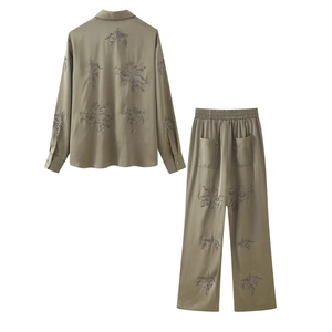 Detailed back view of olive green satin set featuring floral embroidery and beadwork