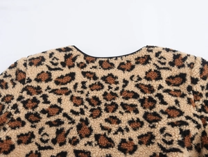 Close-up of fuzzy leopard print fleece fabric and neckline detail on winter jacket