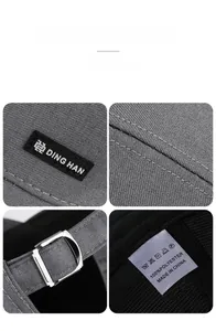 Detail of adjustable metal buckle and stitching on a dark grey polyester baseball cap