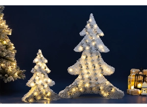 Detail of light-up flocked Christmas tree decor with warm LED lights and pine cones