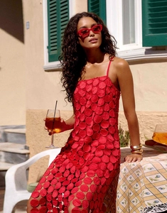 Detail of red hollow-out midi dress with decorative polka dots and chic tassels for summer