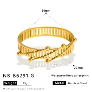 Detailed view of golden stainless steel bangle with diamond pattern, 22mm width